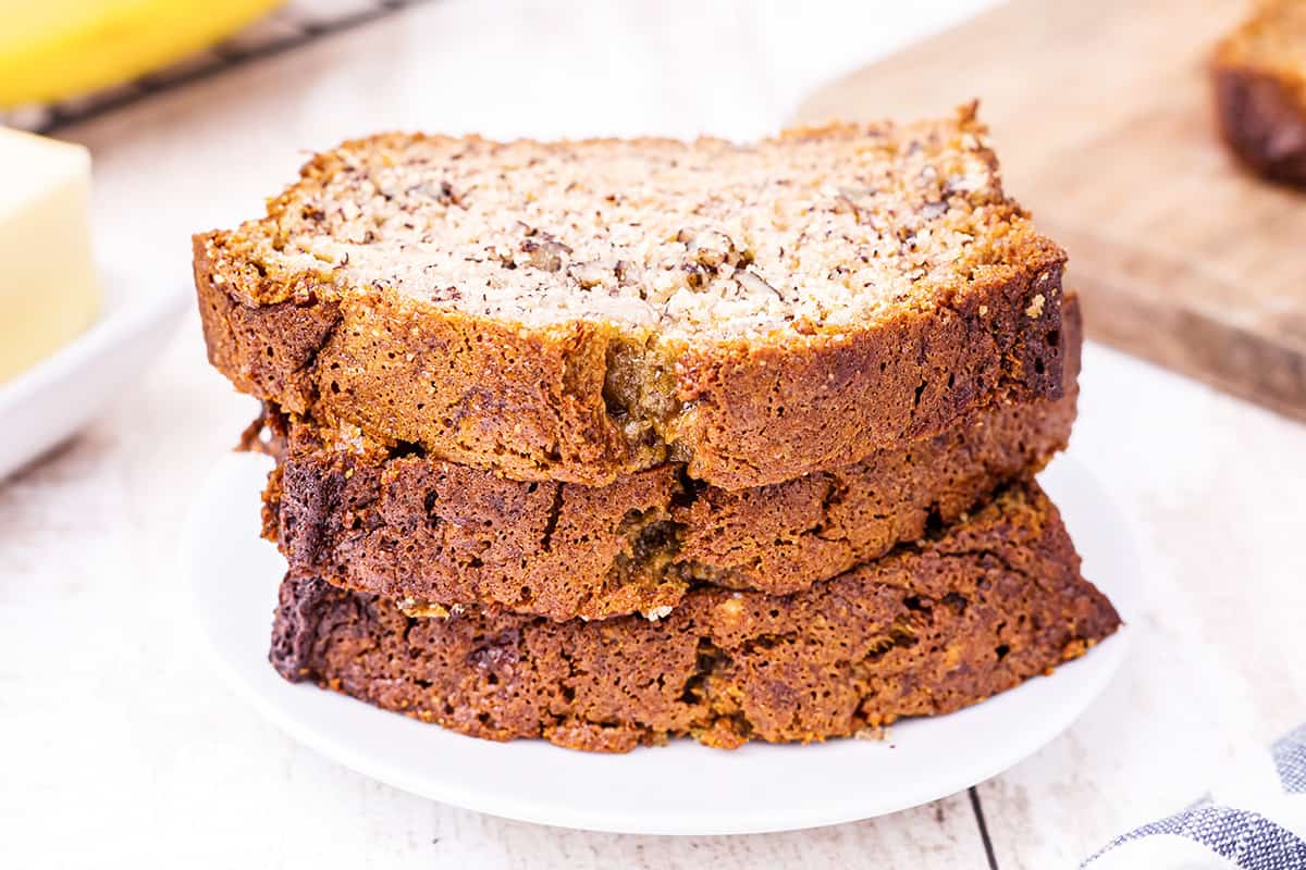 Three slices of buttermilk banana nut bread on a serving plate.