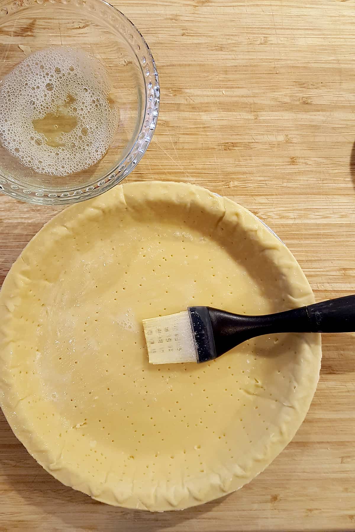 Thawed pie crust brushed with beaten egg white.