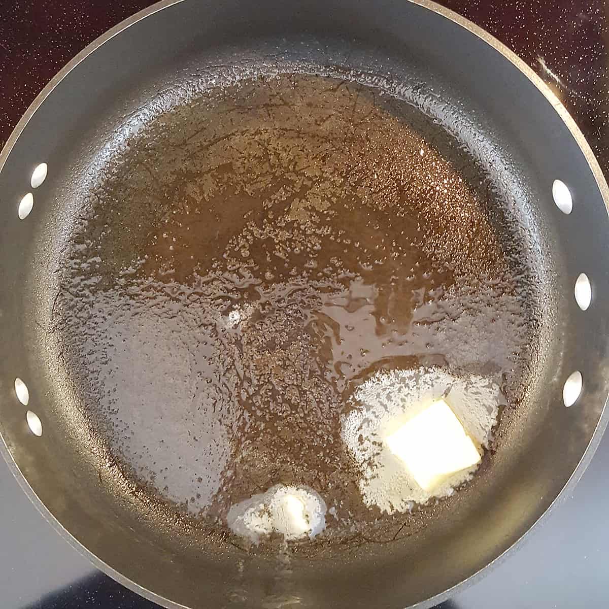 Skillet with butter and oil melting.