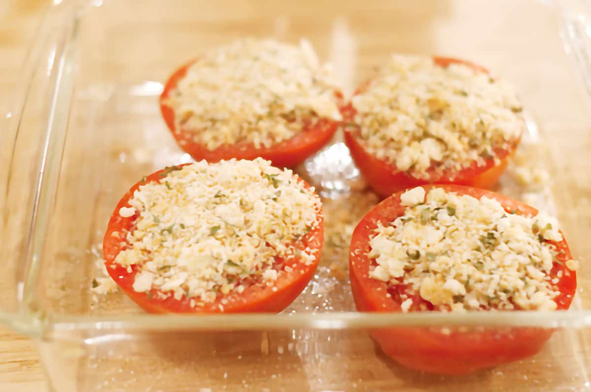 Tomato halves topped with breadcrumb mixture in a baking dish.