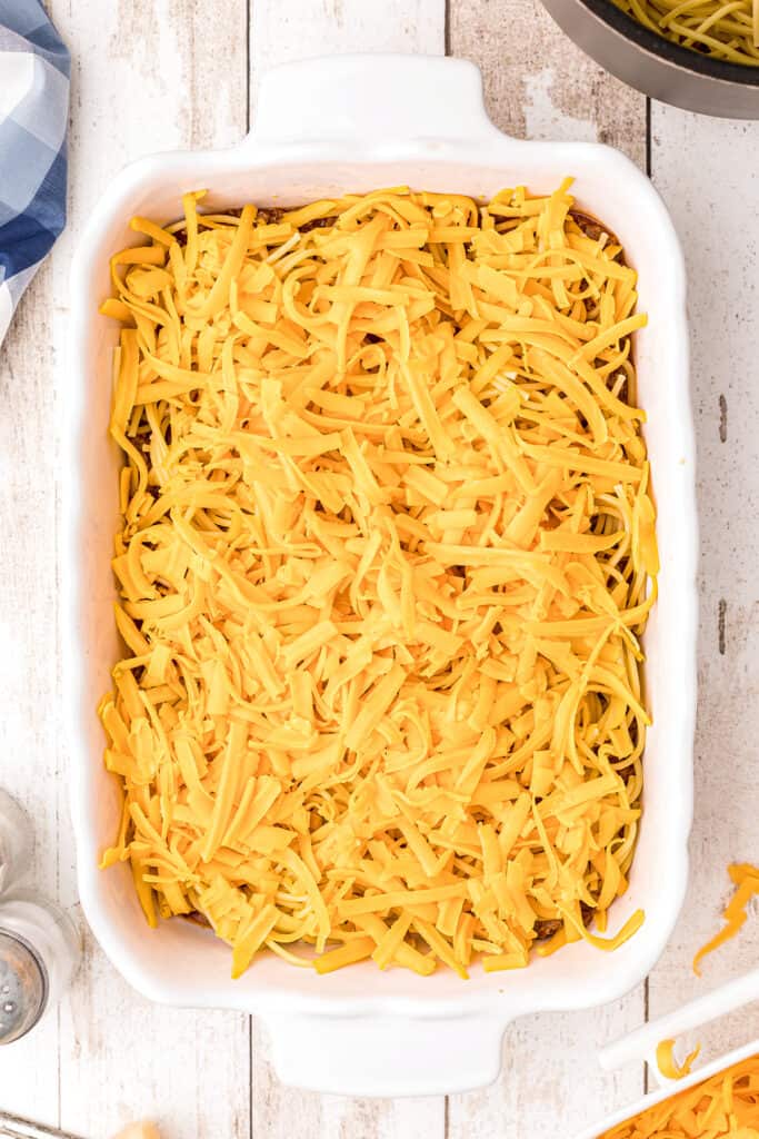 Third layer, cheddar cheese, in casserole dish.