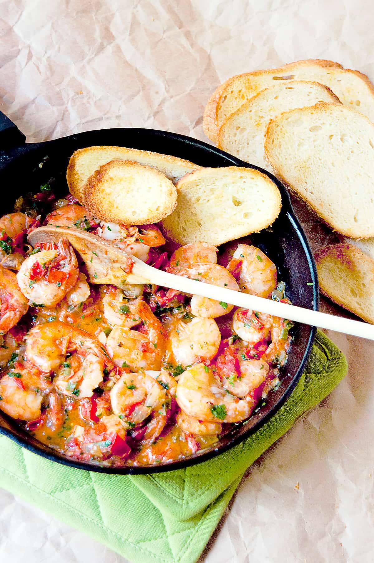 Cilantro Lime Shrimp in a cast iron skillet with garlic bread on the side.