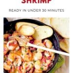 Shrimp cooked with cilantro and lime in a skillet, served with toasted bread slices on the side.