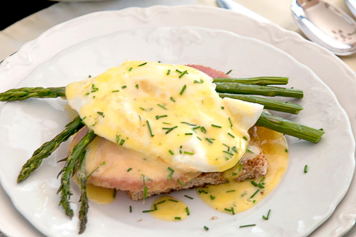 Country eggs benedict on a white serving plate.