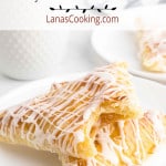 Peach turnovers on a white serving plate.
