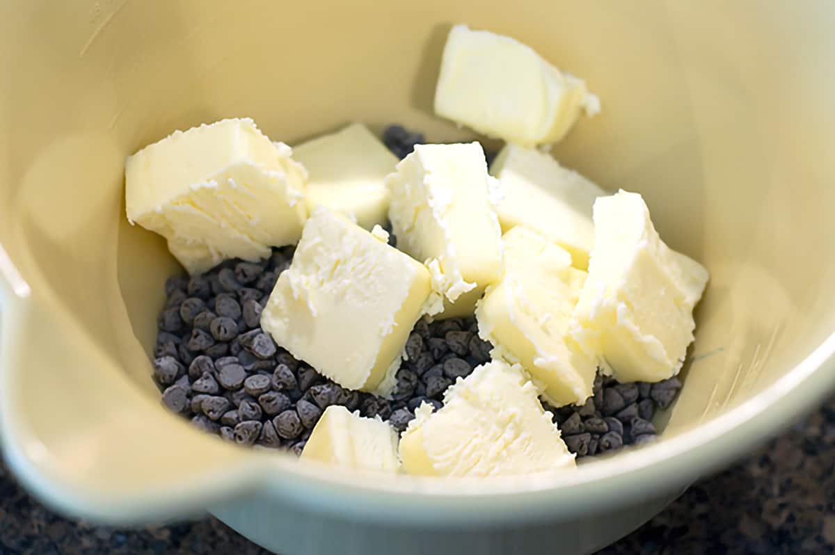 Chocolate chips and butter in a mixing bowl.