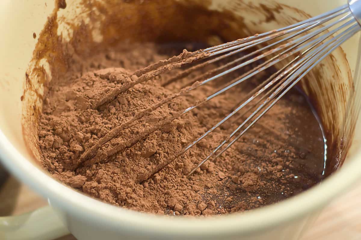 Mixture in mixing bowl with cocoa powder added.