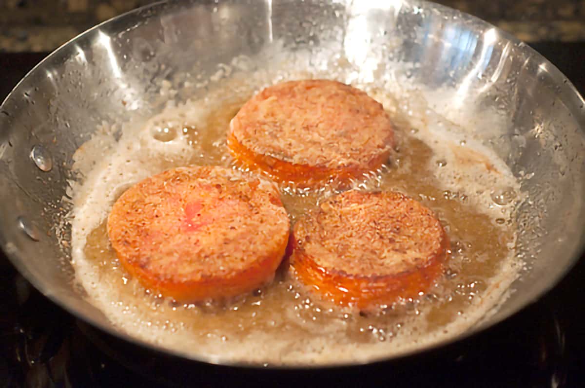 Tomatoes frying in bacon fat.