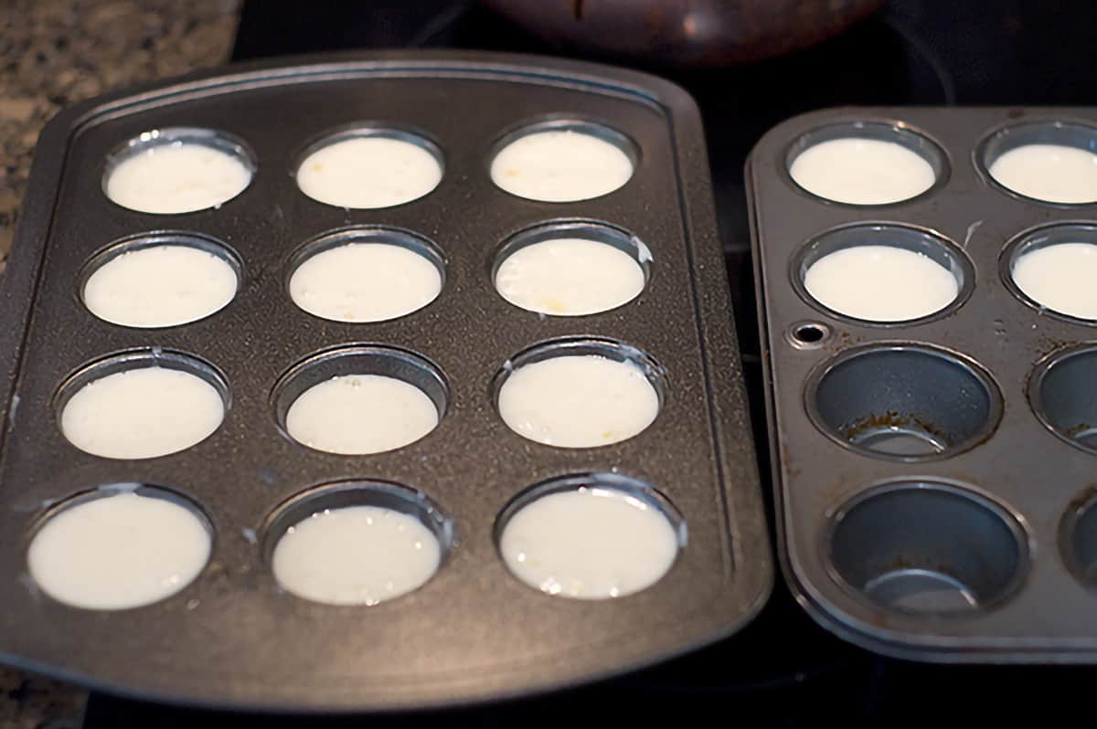 Mini muffin tins filled with batter.