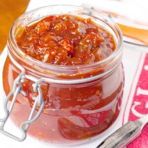 Finished tomato jam in a wire bail top storage jar.