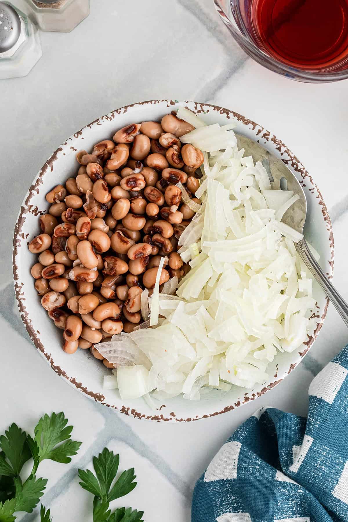 Black eyed peas and onions in a bowl.