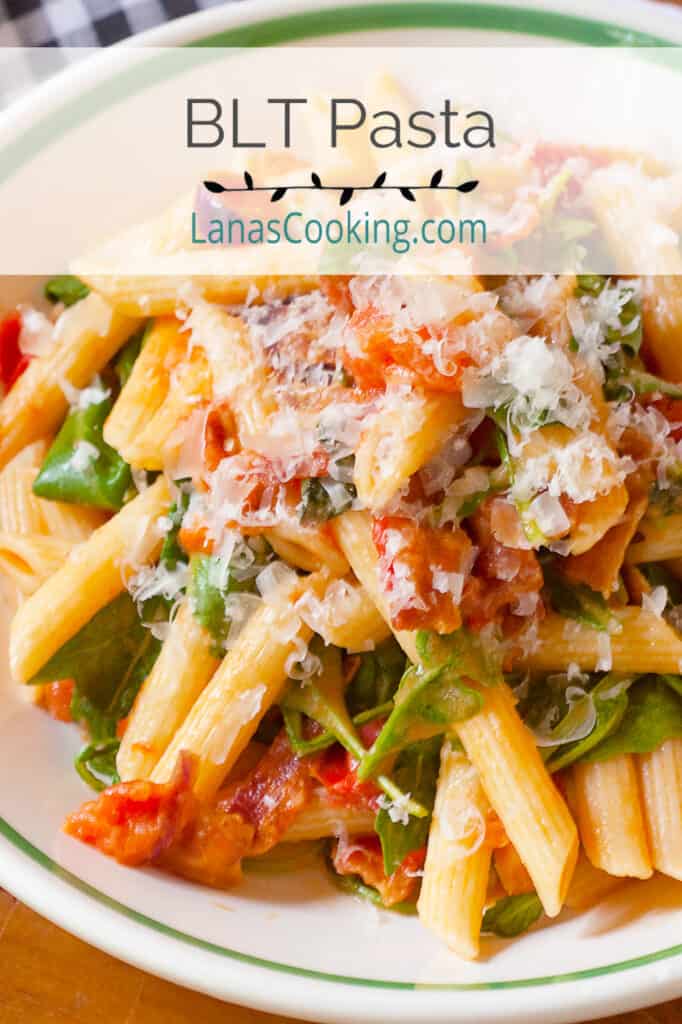 BLT pasta in a serving bowl with a napkin and cutlery alongside.