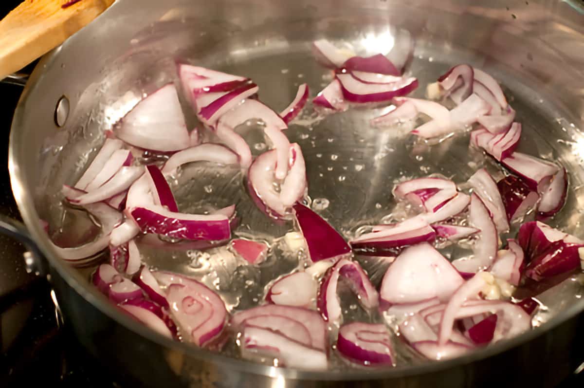 Red onion cooking in a skillet.