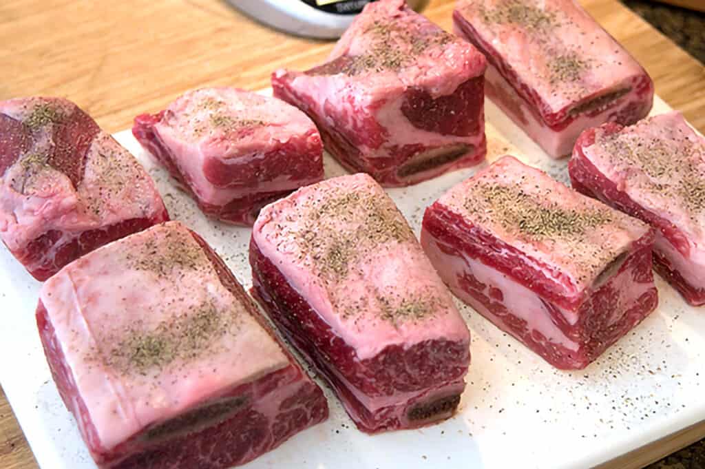 Beef short ribs sprinkled with salt and pepper.
