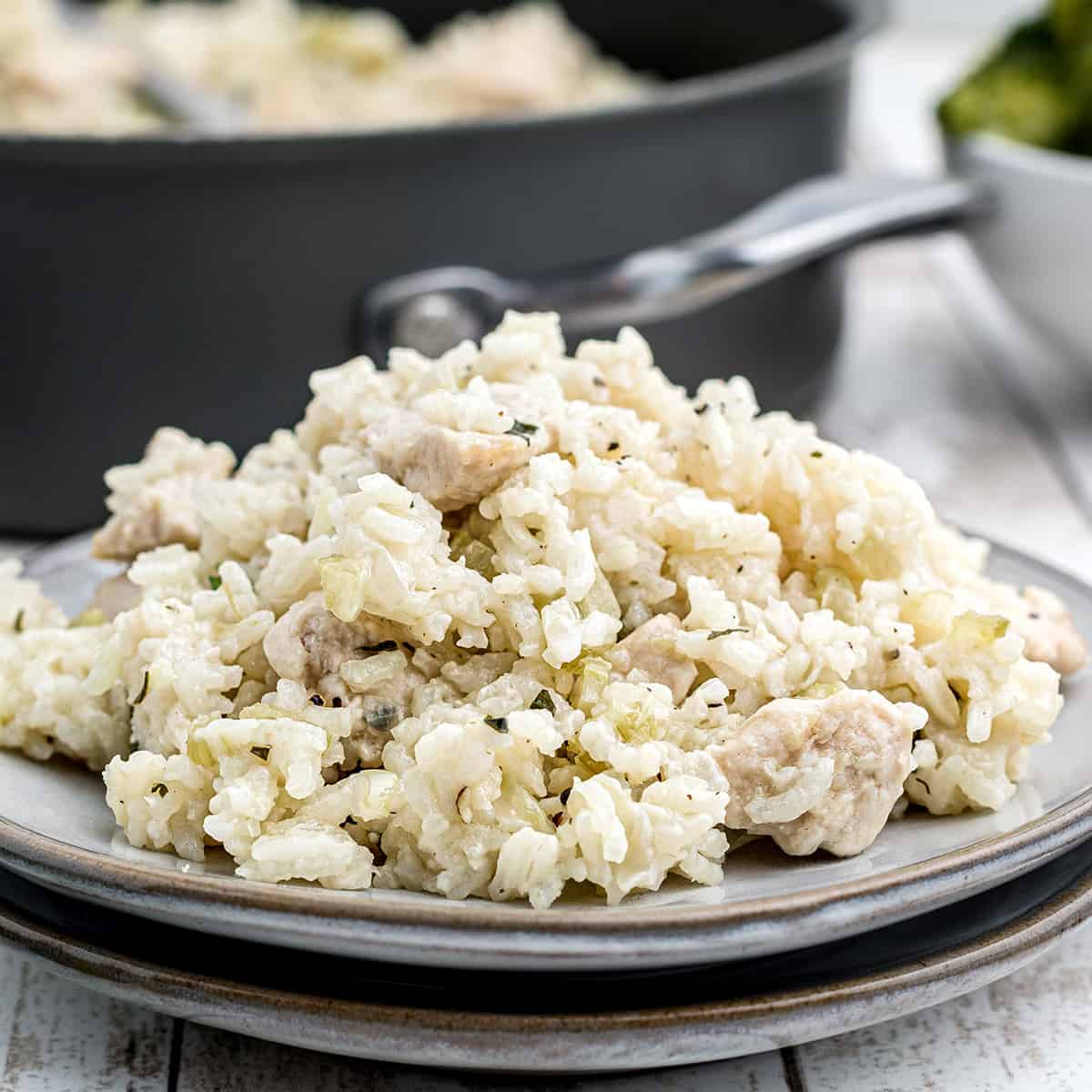 A serving of chicken and rice on a white plate.