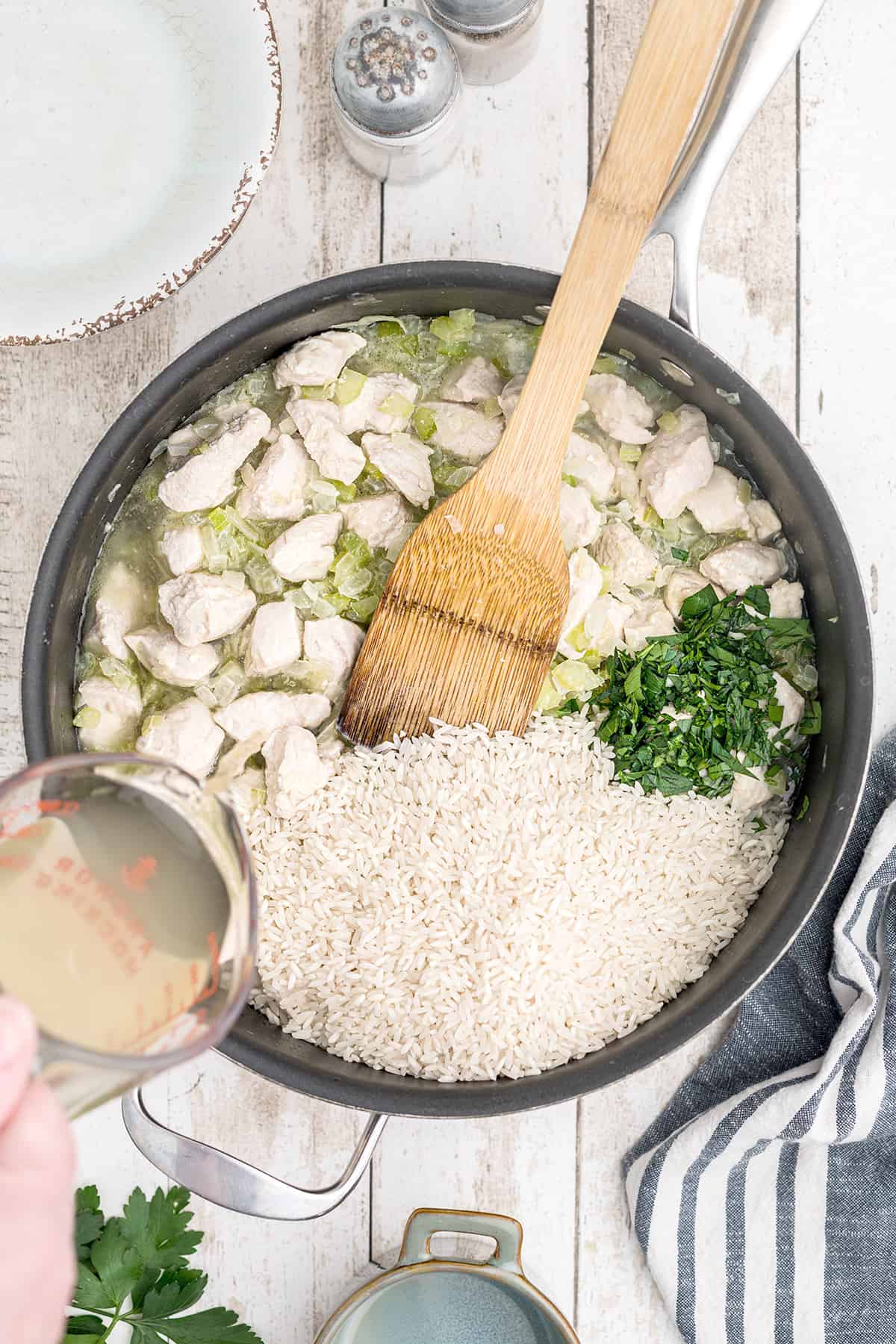 Rice, stock, and parsley added to the skillet.