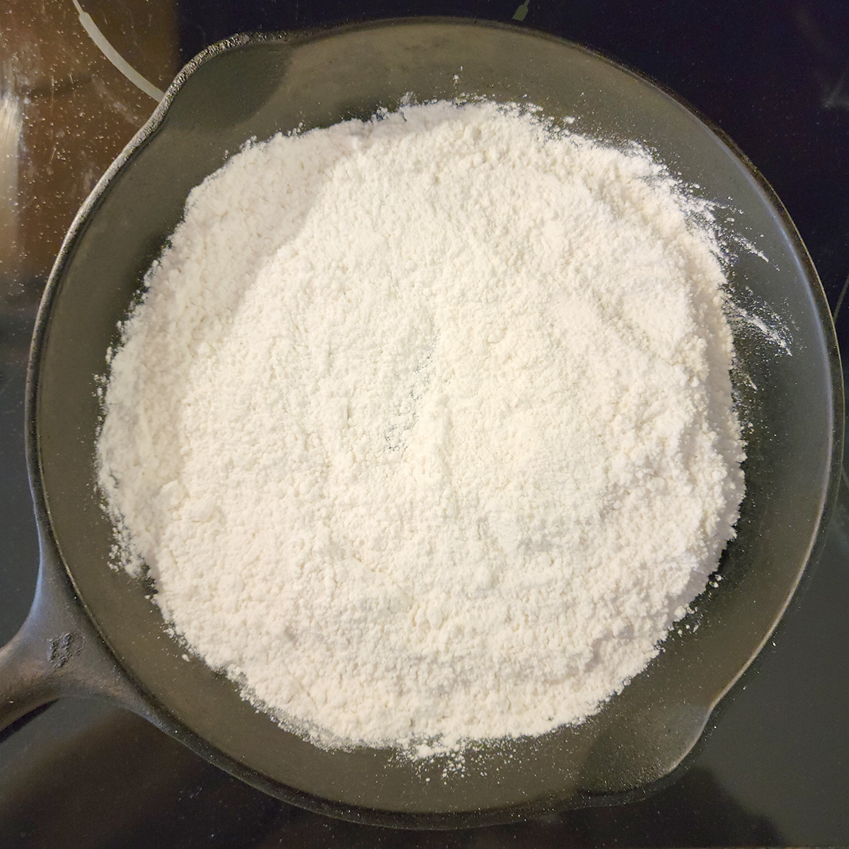 Flour in a cast iron skillet.