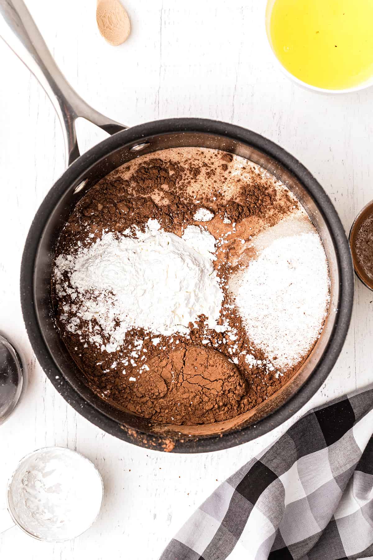 Medium saucepan with sugar, cocoa, salt and cornstarch.