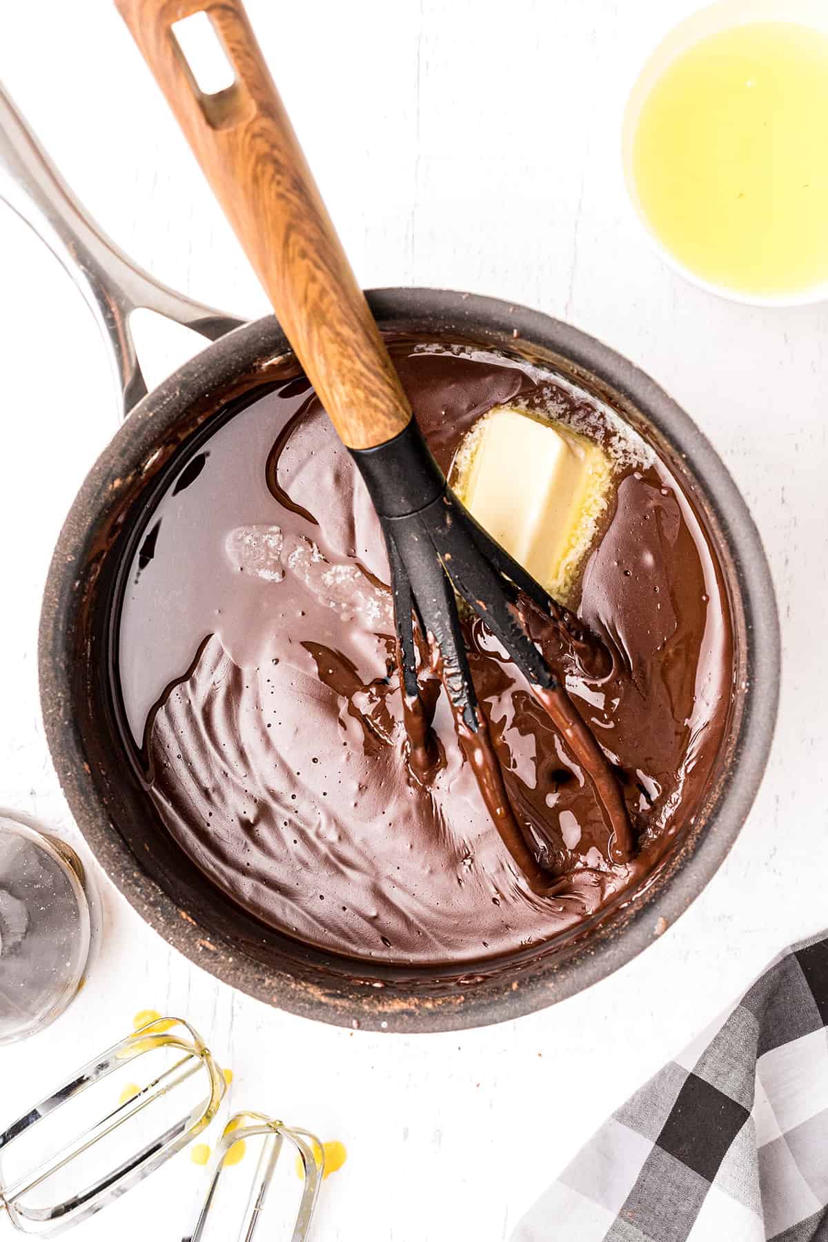 Adding butter and vanilla to the cooked custard mixture.