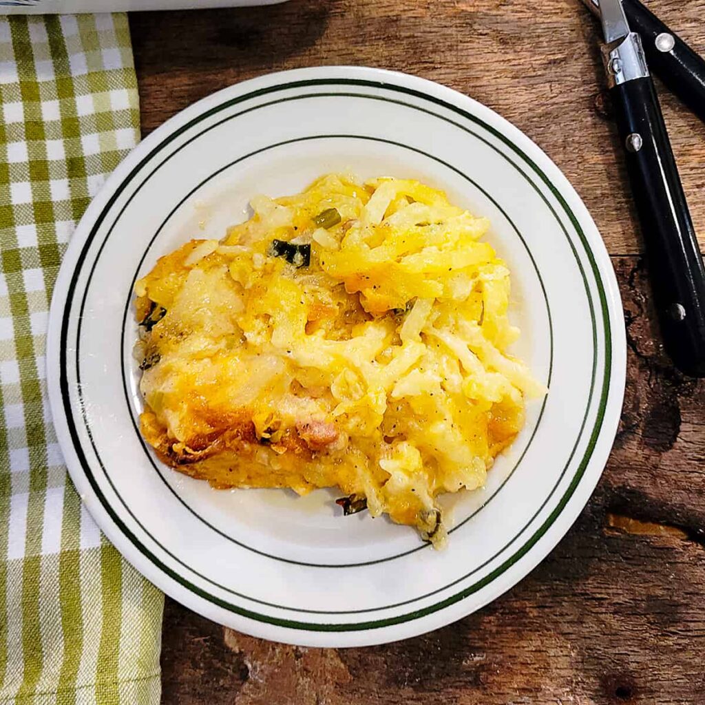 A serving of copycat cracker barrel hash brown casserole on a plate.