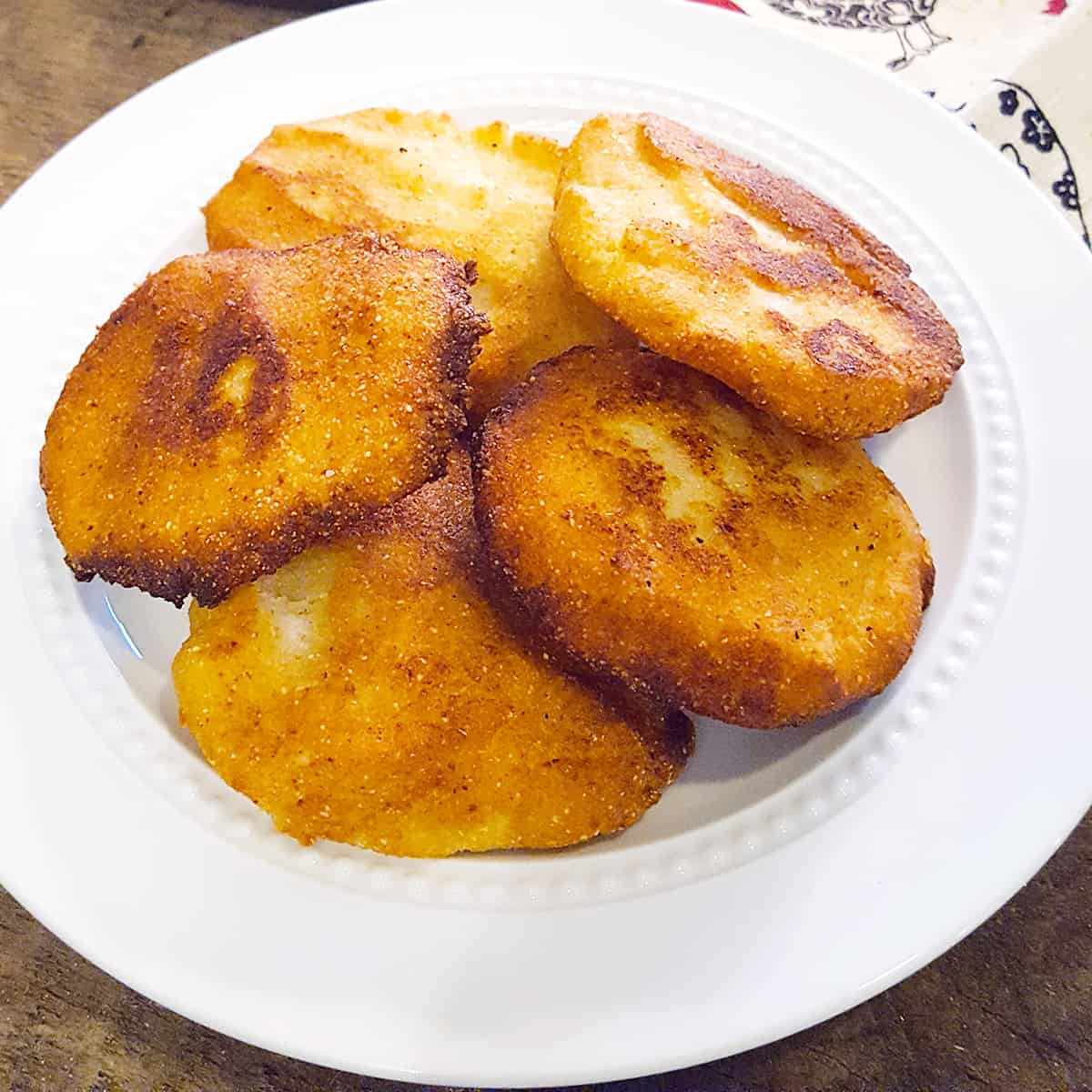 Finished Easy Hot Water Cornbread on a white serving plate.