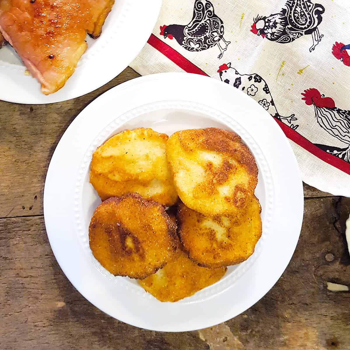 Finished cornbread on a white serving plate.