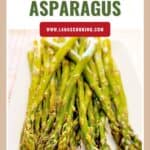 A plate of oven roasted asparagus spears with a Oven Roasted Asparagus title above.