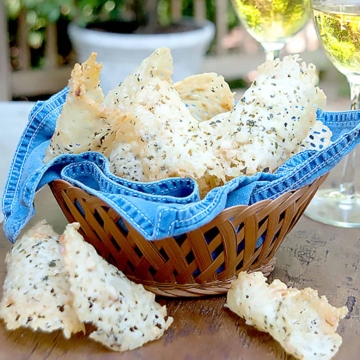 Cheese crisps in a basket with a blue napkin.