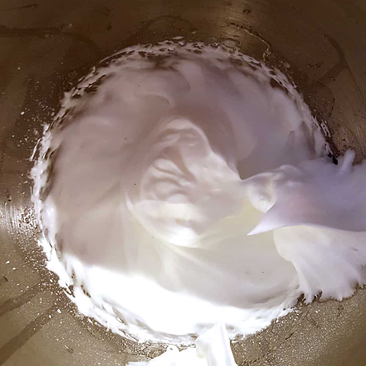 Beaten egg whites in a mixing bowl.