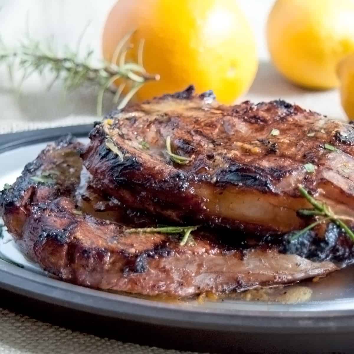 Two ribeye steaks on a platter.