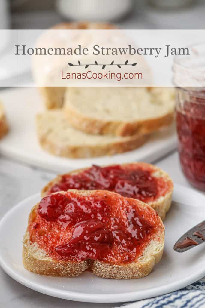 Strawberry jam spread on toast set on a white plate.
