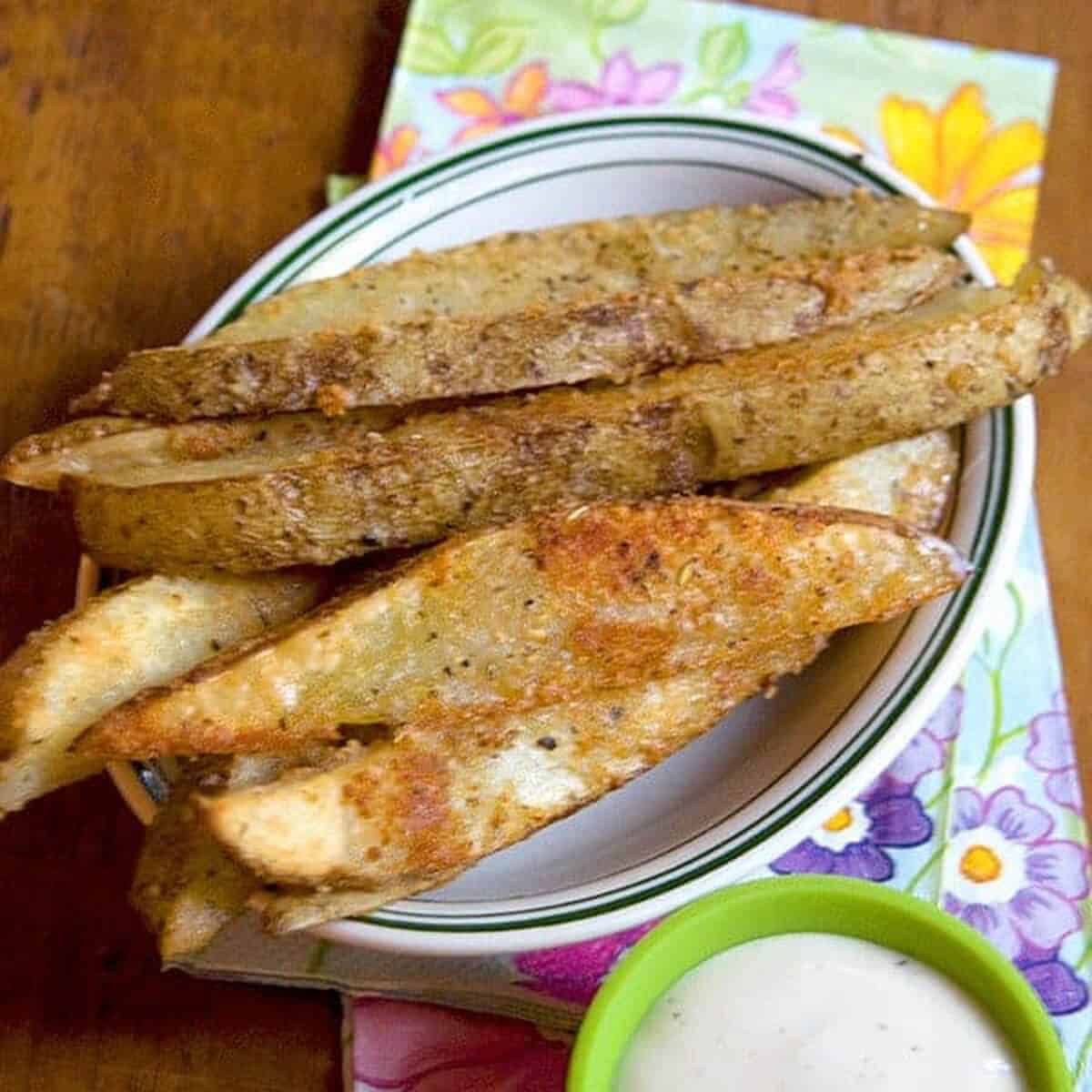 Baked potato wedges in a white dish.