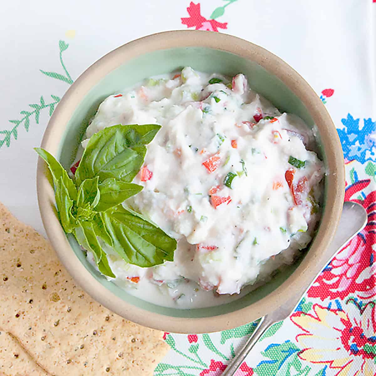 Ricotta veggie spread in a vintage green bowl.