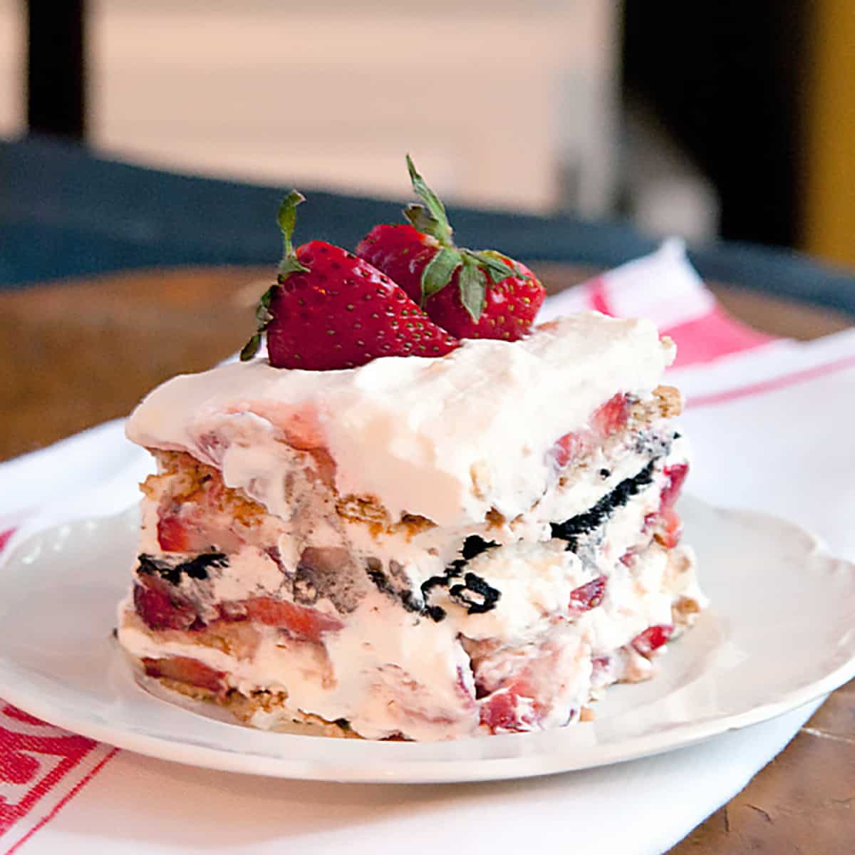 A serving of strawberry icebox cake on a white plate.