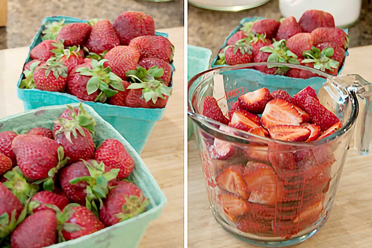 Halved fresh strawberries in a measuring cup.