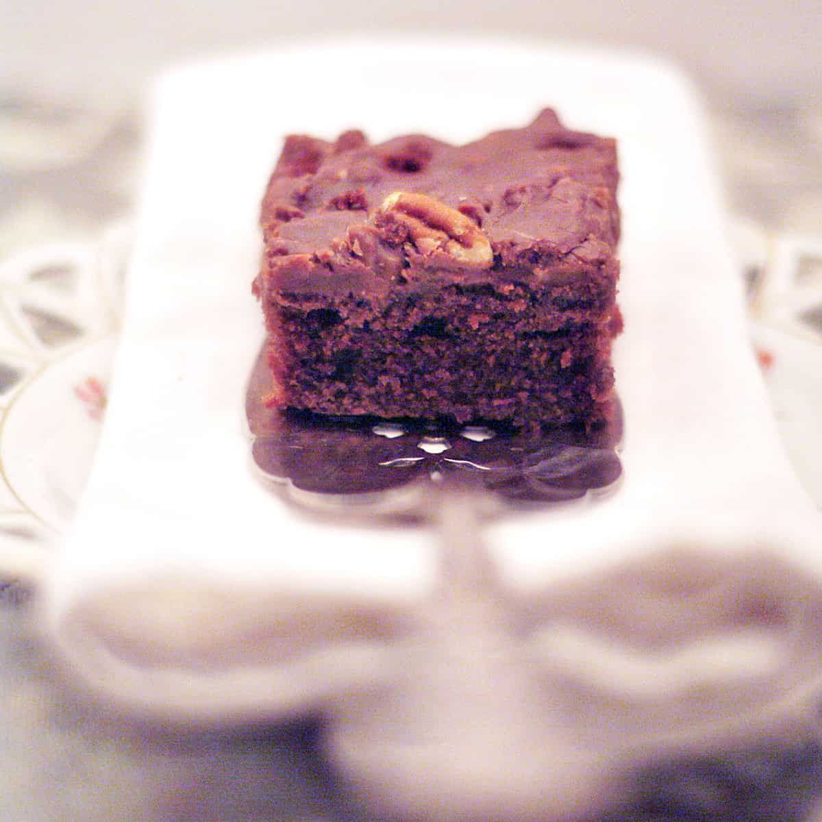 A slice of Texas sheet cake on a white napkin.