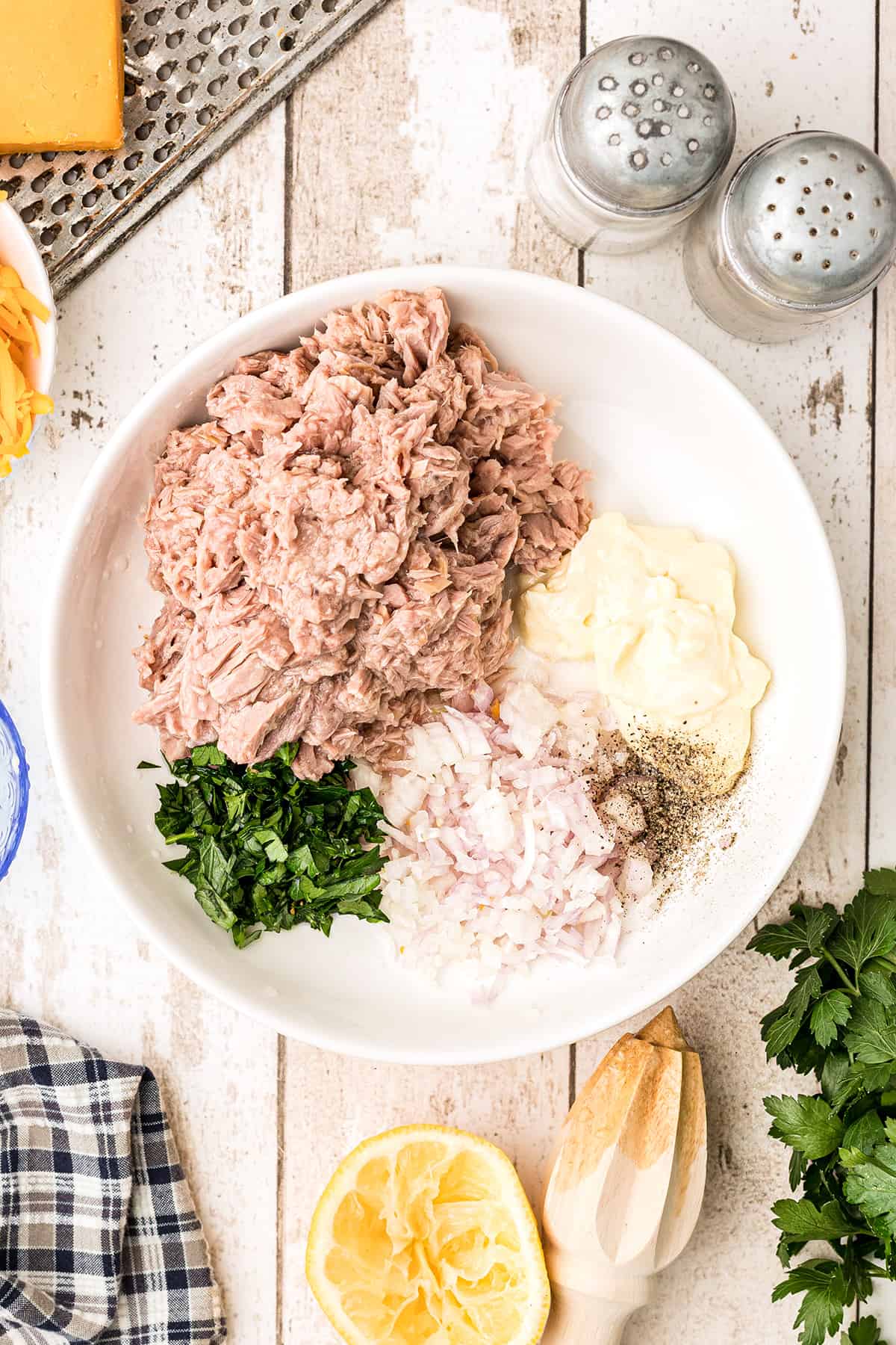 Ingredients for the tuna sandwich filling in a mixing bowl.