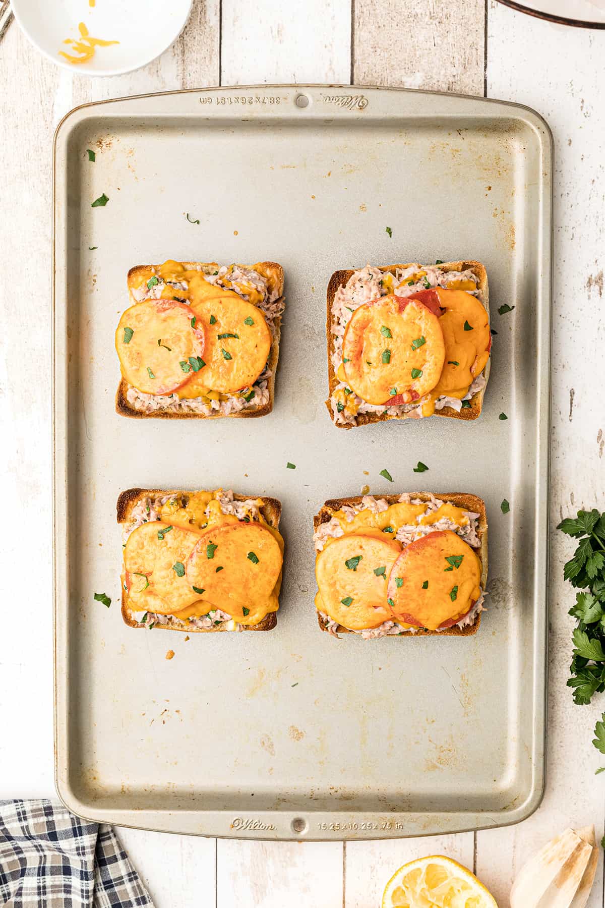 Finished sandwiches on a baking sheet.