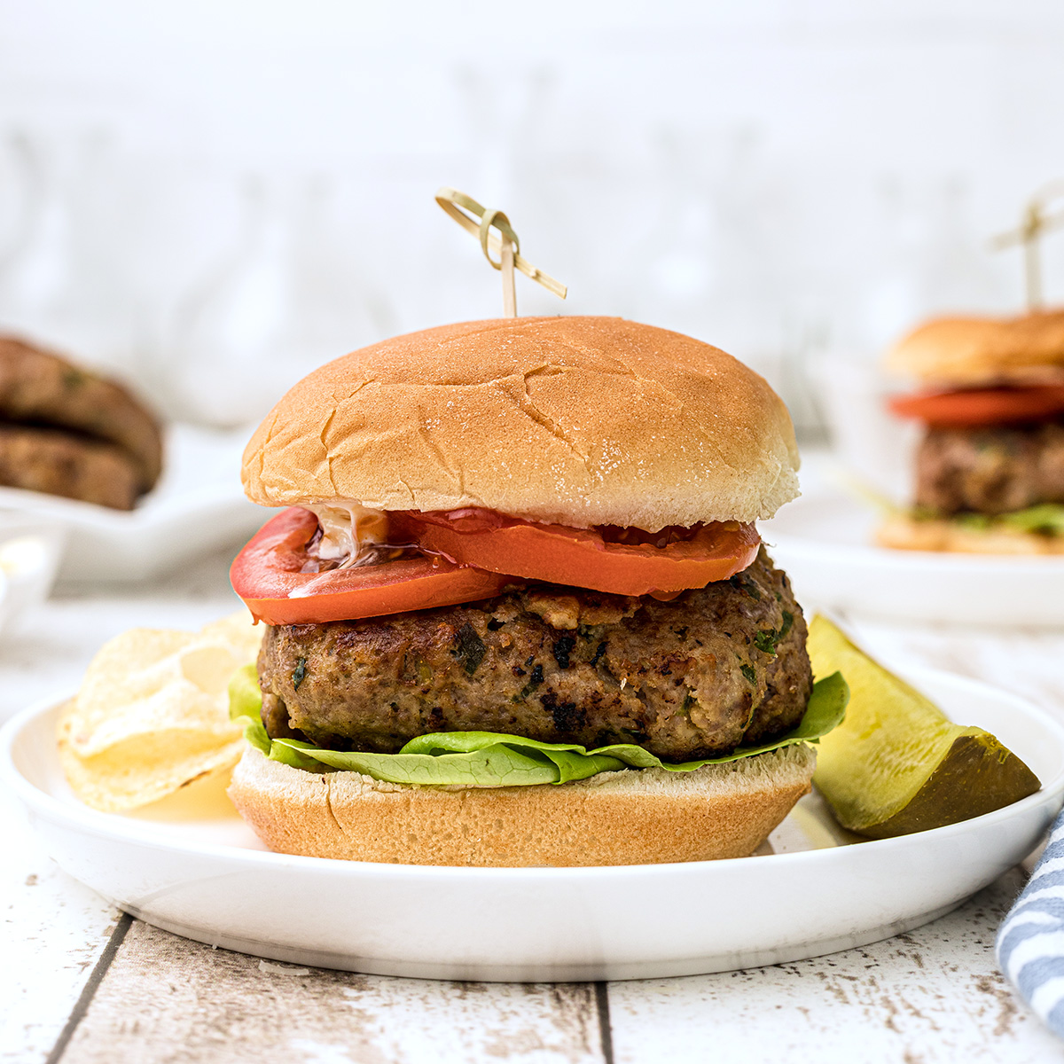 Finished turkey burger on a white serving plate.