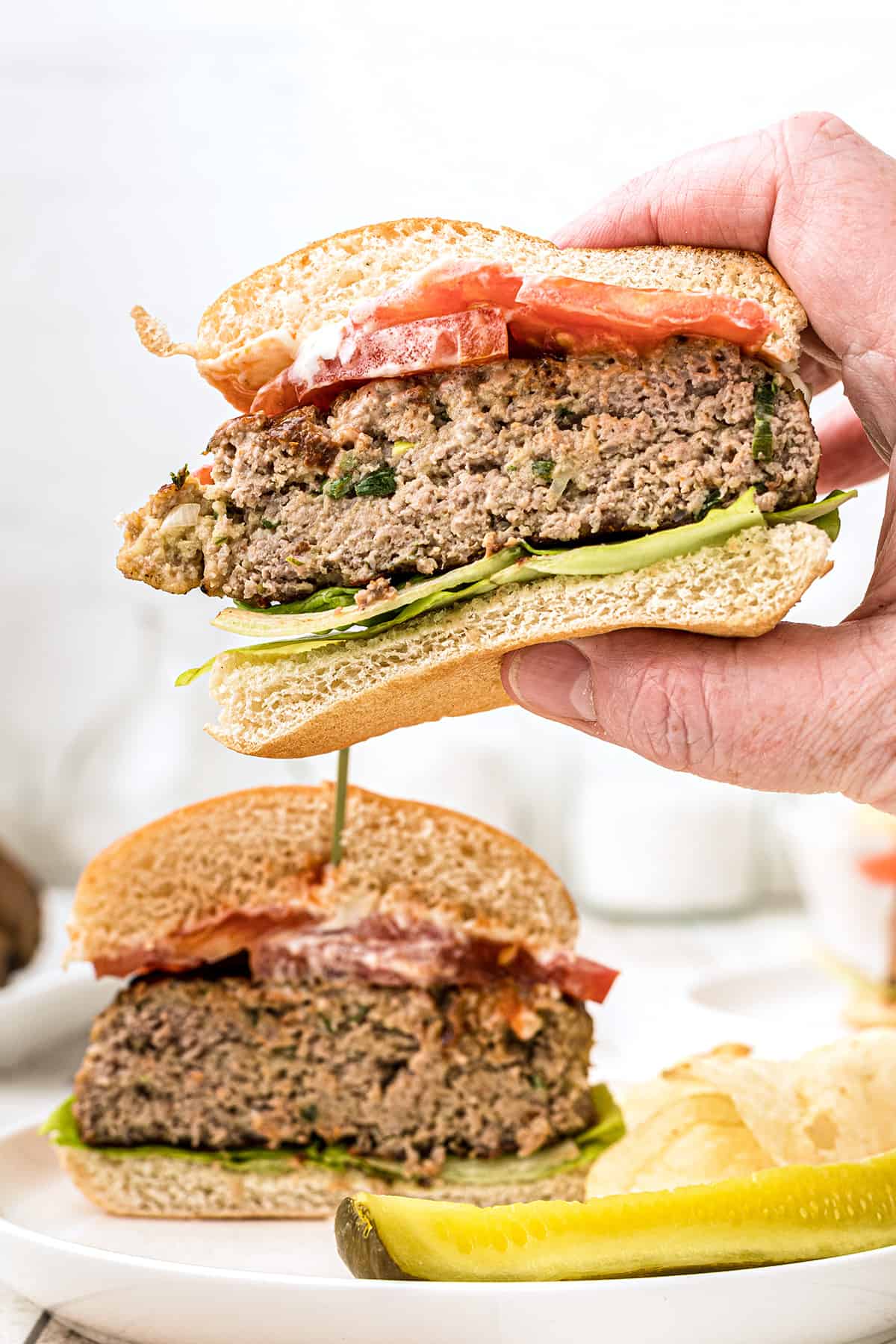 Turkey burger cut in half with a hand holding one portion.