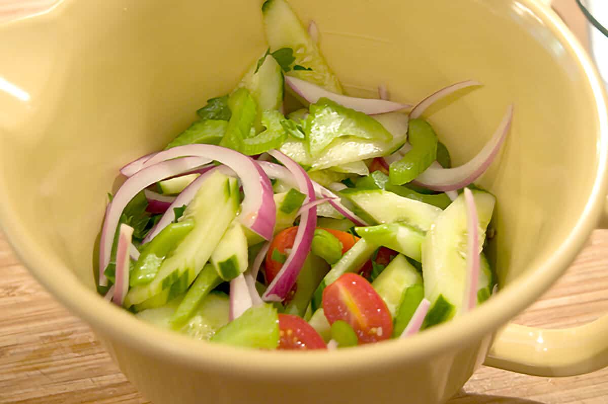 Prepared salad vegetables in a bowl.