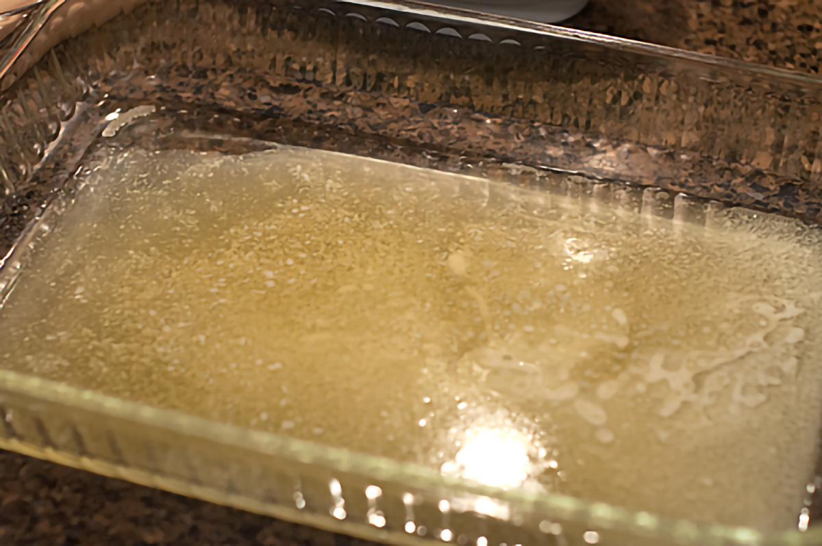 Melted butter in a 9x13 baking dish.