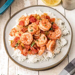 A serving of Louisiana Shrimp Creole over white rice on a plate.
