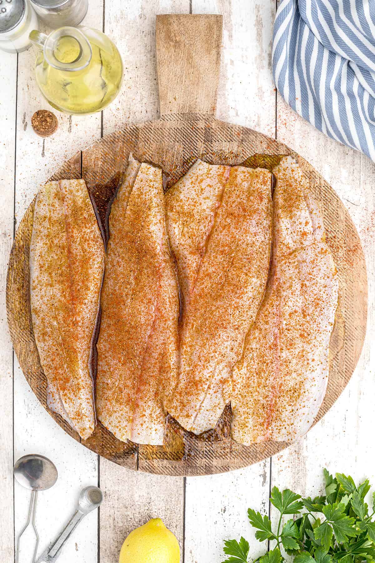 Fish fillets sprinkled with seasonings.