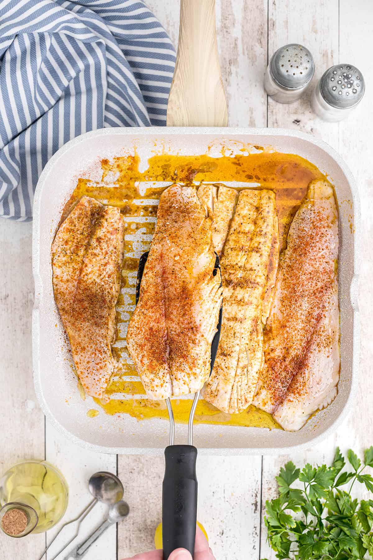 Fish fillets cooking in a grill pan.