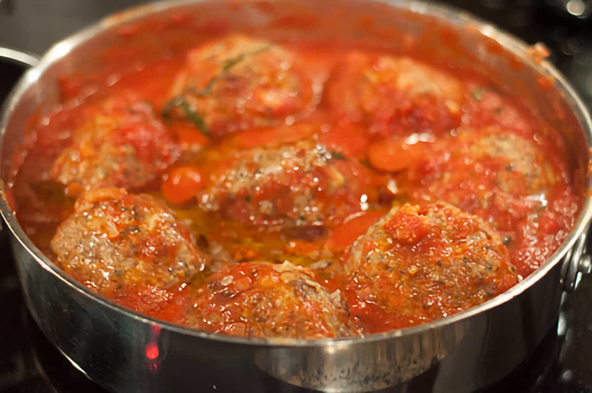 Browned meatballs added to the tomato sauce.