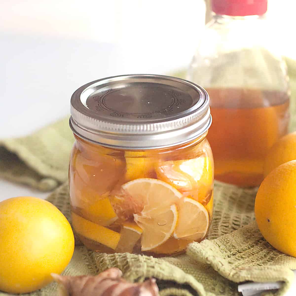 Lemon, honey, and ginger in a small mason jar.