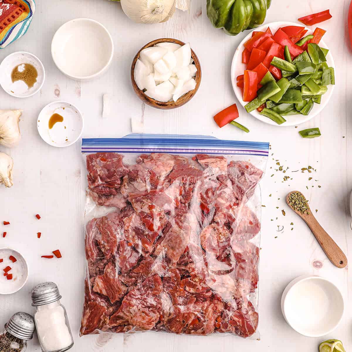 Skirt steak marinating in a plastic bag.