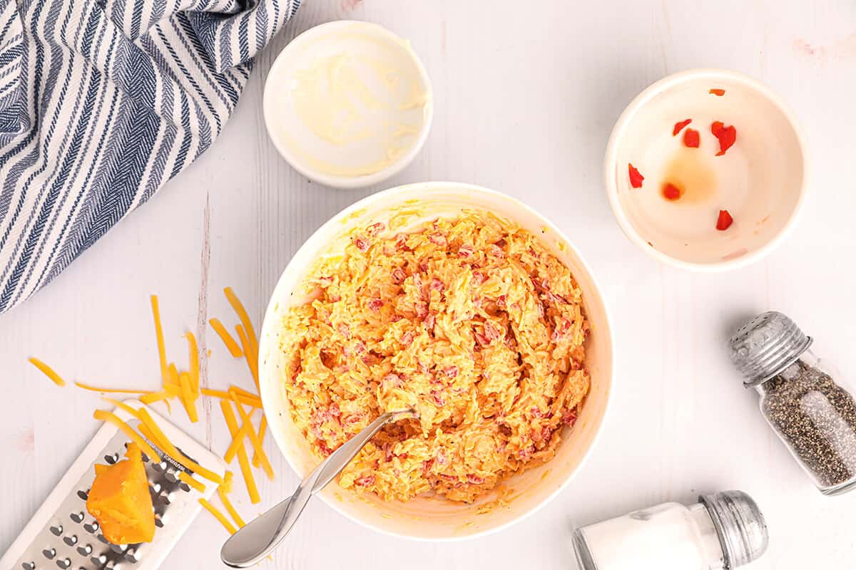Mixed pimiento cheese in a white bowl.