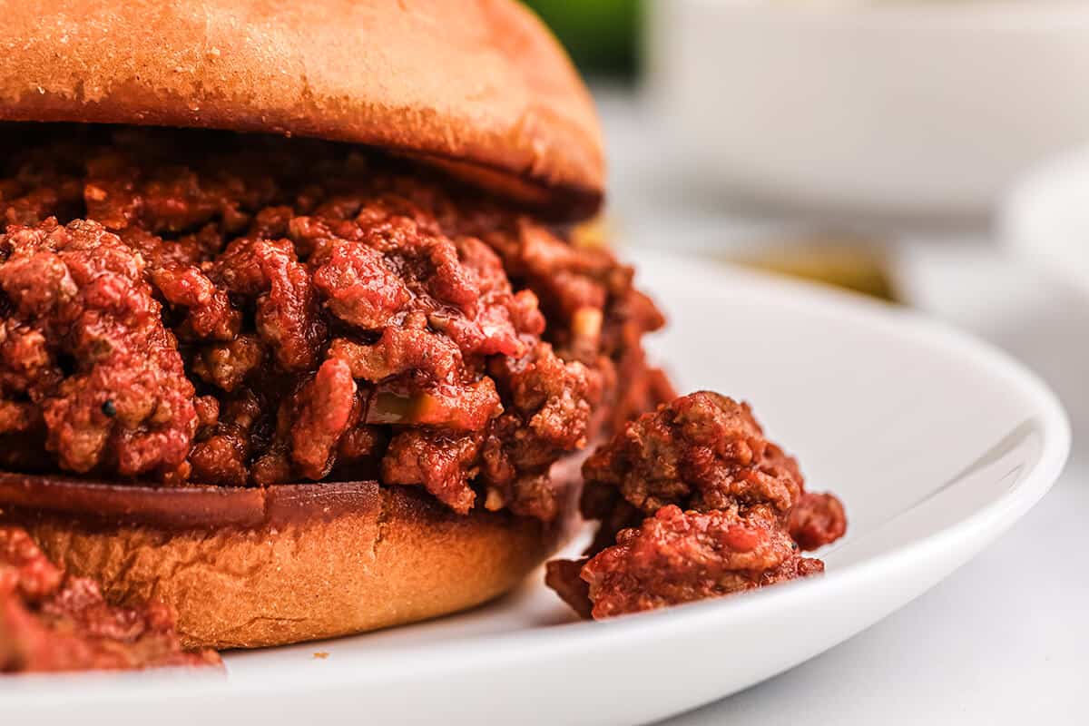 Sloppy Joe sandwich on a white serving plate.